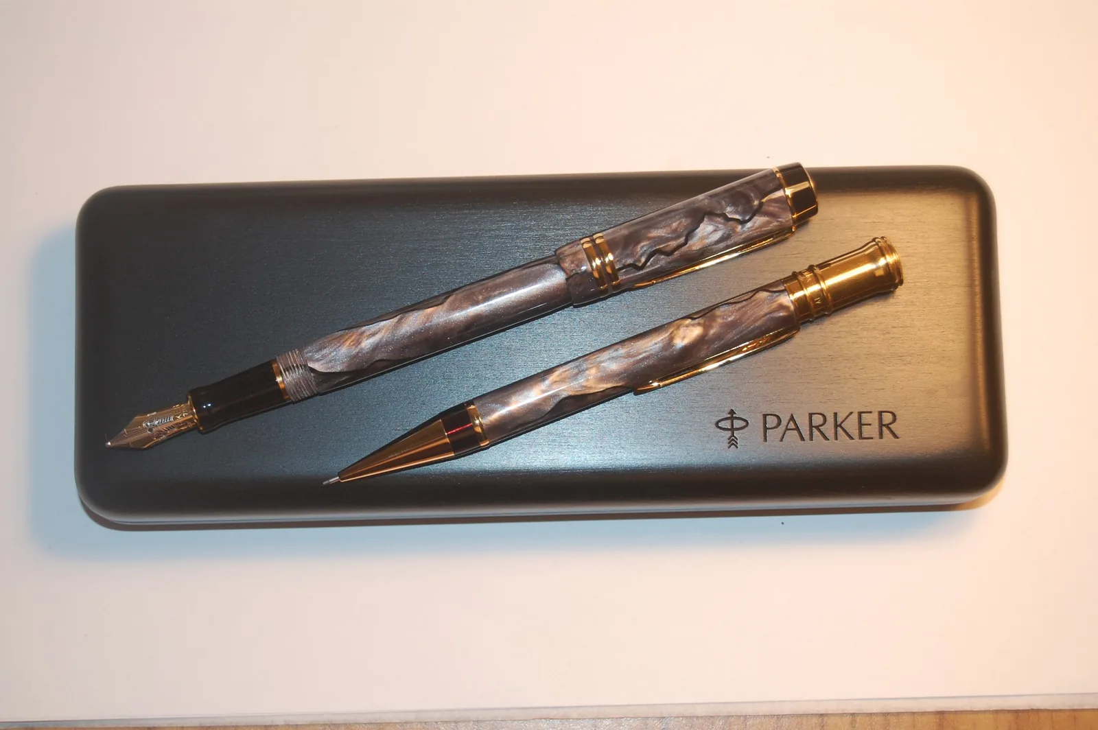 Collection tray filled with fine writing instruments in red, pearl, gold and silver finishes
